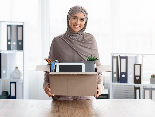 a girl carrying a box