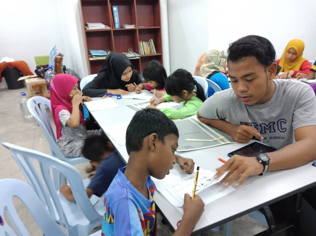 Five children reading a book
