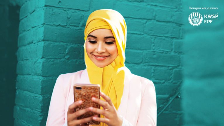 Muslim woman happily playing with her mobile device