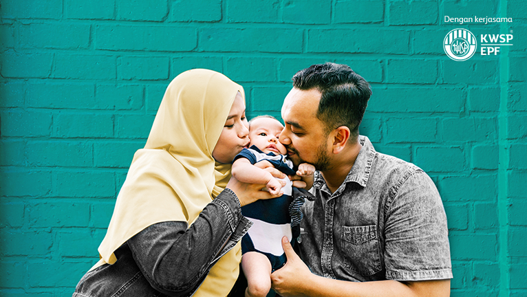 Muslim father and mother kissing a baby