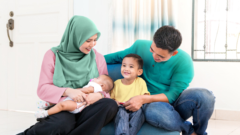 Happy Muslim family with son and baby